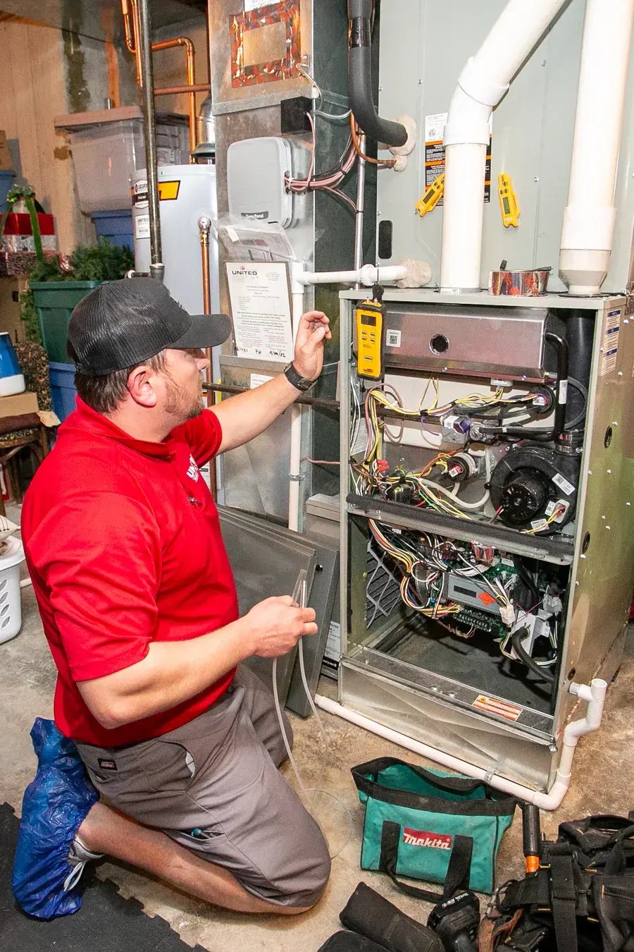 United Heating technician fixing a furnace