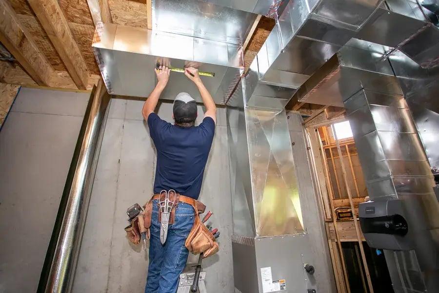United Heating technician installing new HVAC system