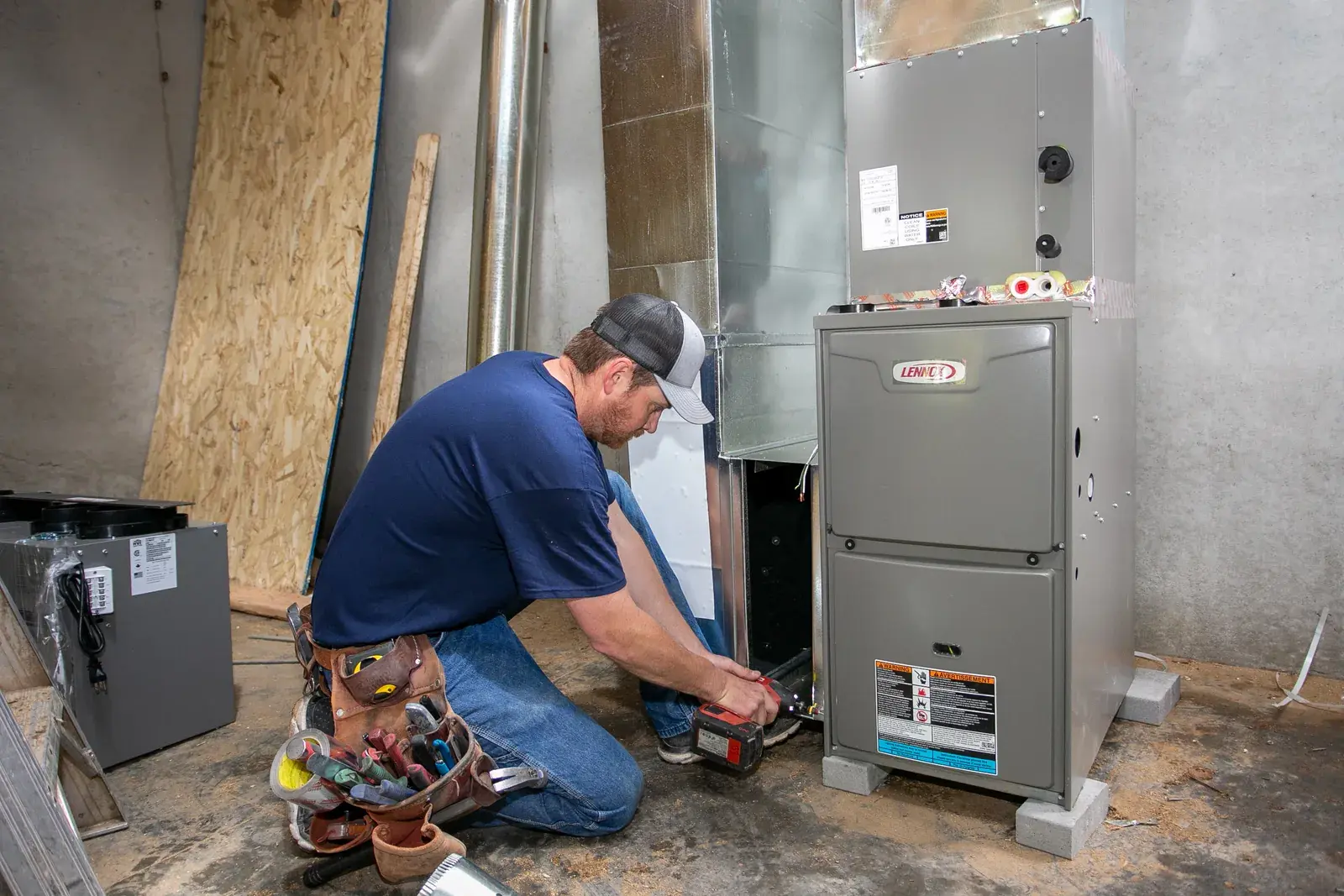 United Heating technician performing an emergency furnace repair United Heating technician performing an emergency furnace repair