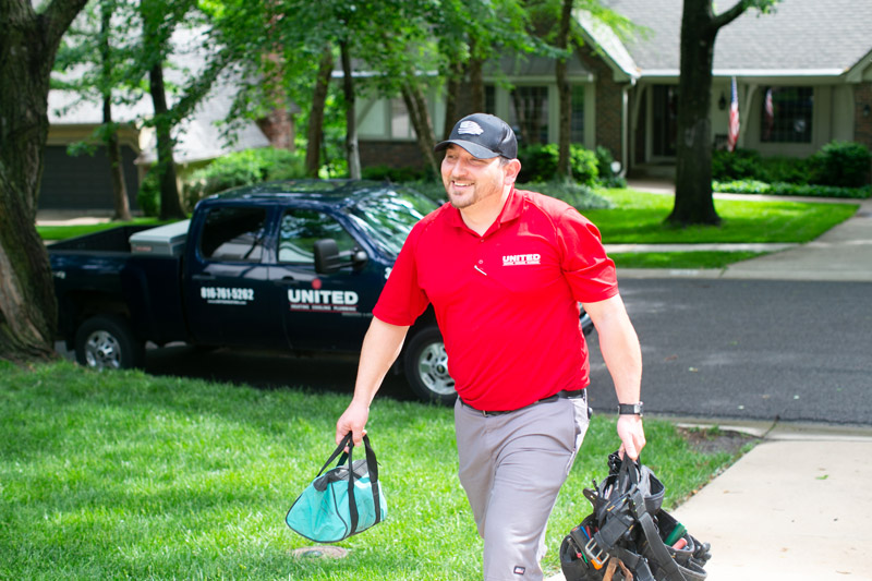 A friendly United technician with his tools ready to provide AC services to a Kansas City home. A friendly United technician with his tools ready to provide AC services to a Kansas City home.