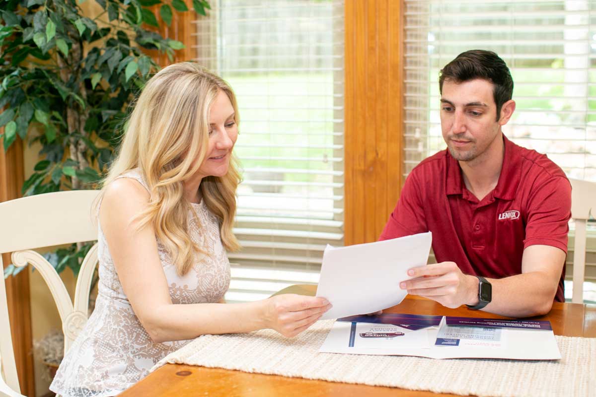 A United Heating representative going over financials and service options with a female client in her home A United Heating representative going over financials and service options with a female client in her home